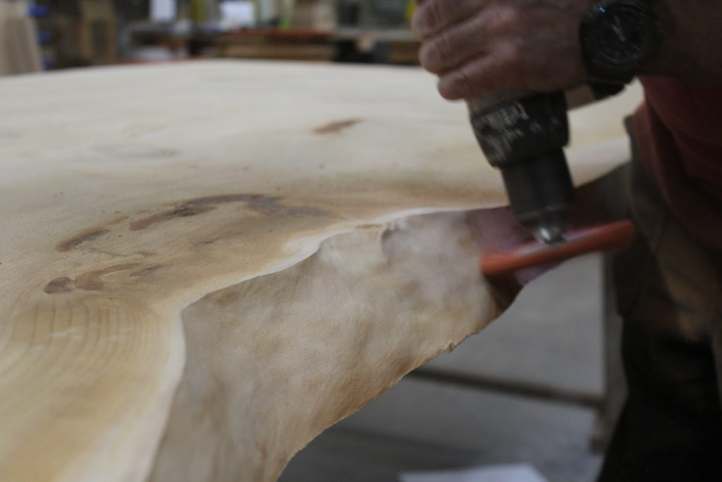 Scrubbing the board with a stiff brush